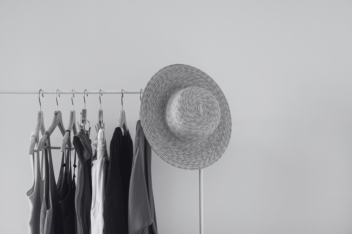 a black and white photo of clothes hanging on a rack