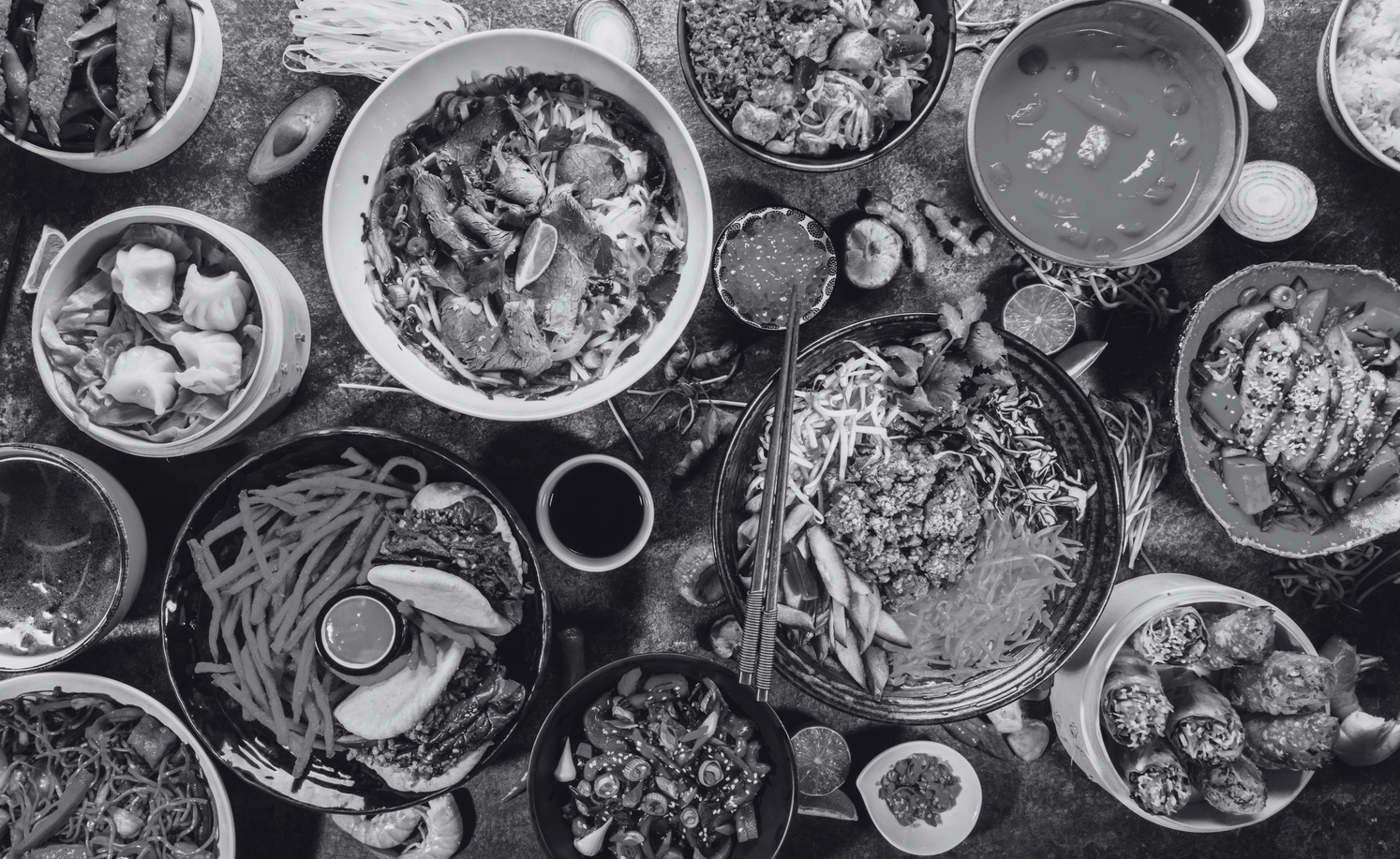 a black and white photo of a table full of food